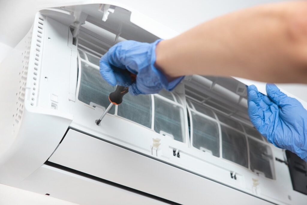 Servicing an Air conditioner with AC unit repair by Clean Air Solutions 